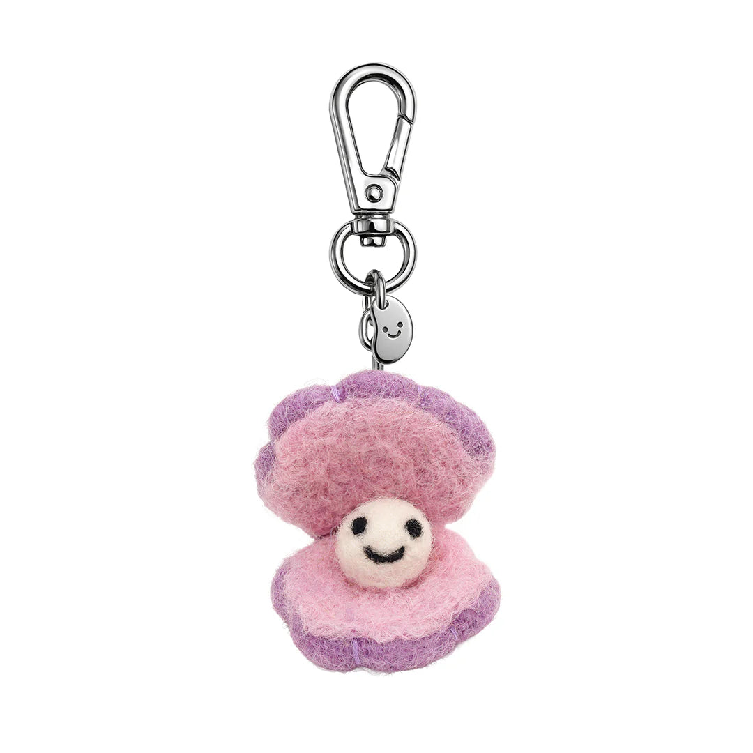 Pink and purple plush clam and pearl keychain with a smiling face on a white background