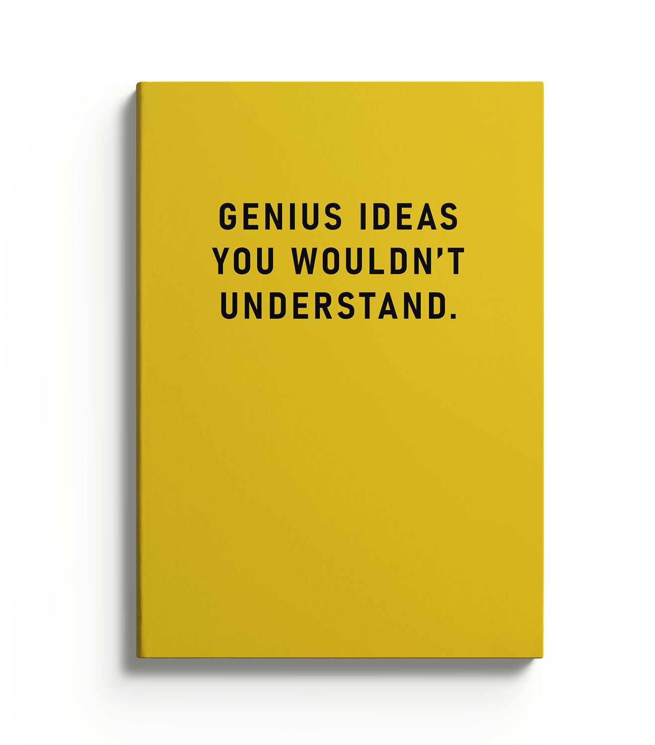 Yellow journal with black text 'GENIUS IDEAS YOU WOULDN'T UNDERSTAND.' on a white background