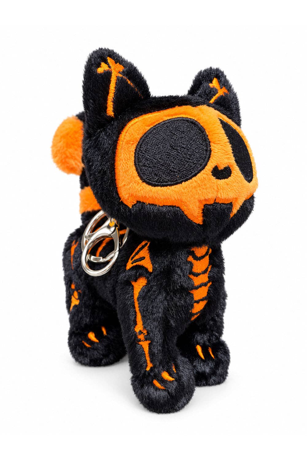 A black plush cat keychain with orange skeleton and eye details, featuring a silver metal keyring, set against a plain white background.