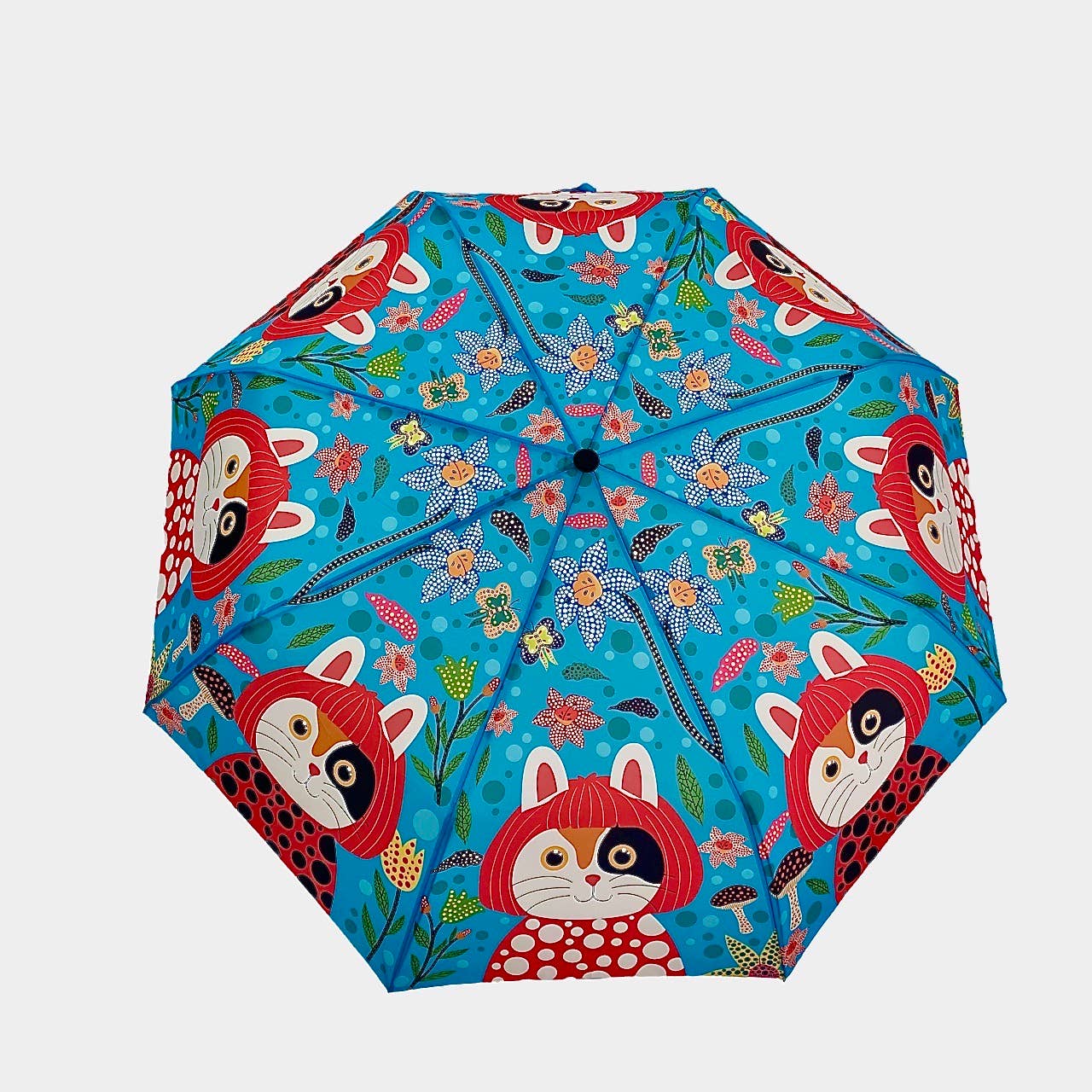 Colorful umbrella with fox and floral pattern on a blue background