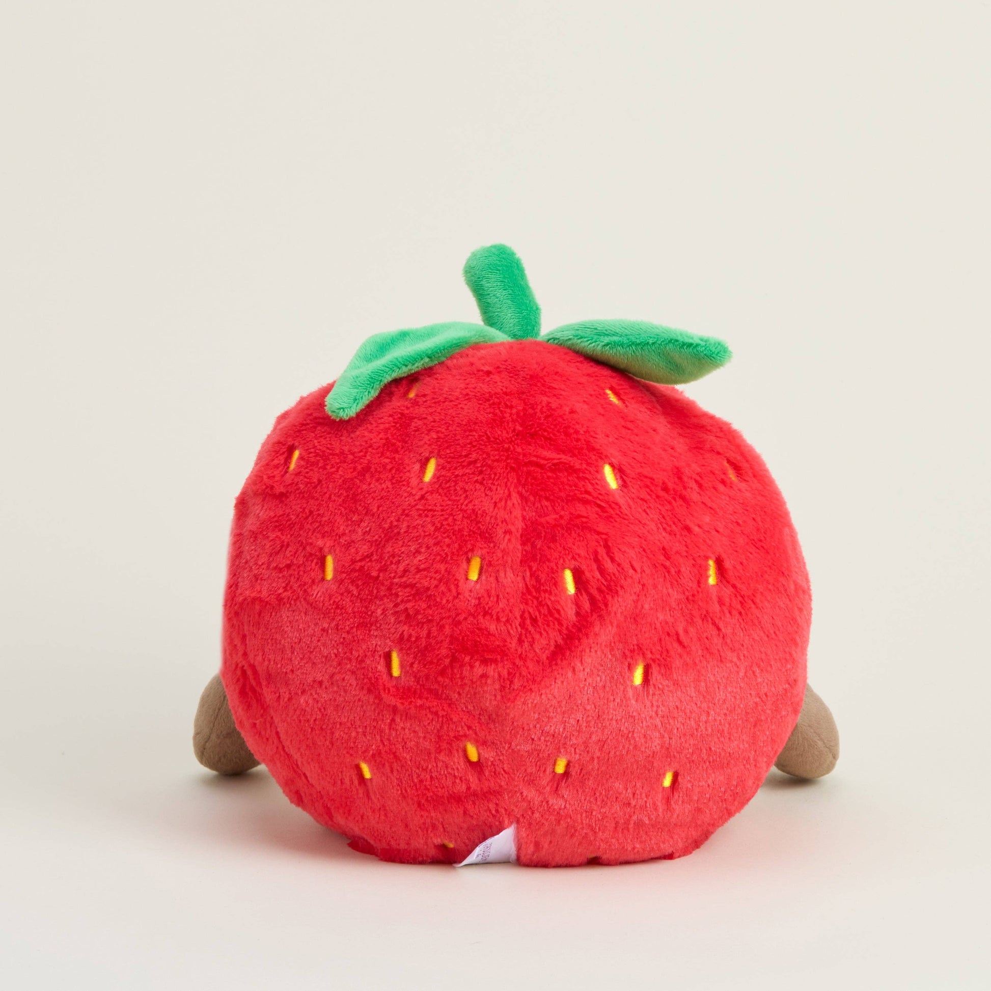 Plush strawberry toy on a light gray background