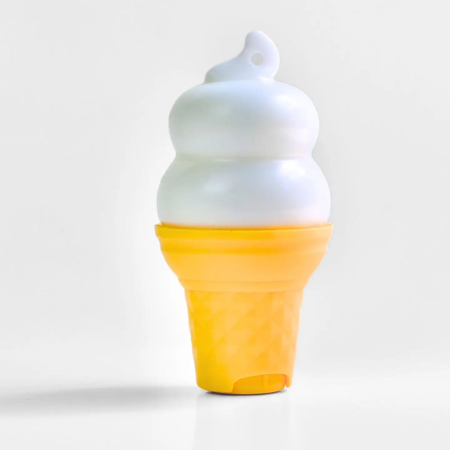 Ice cream cone-shaped container with lotion on a light gray background