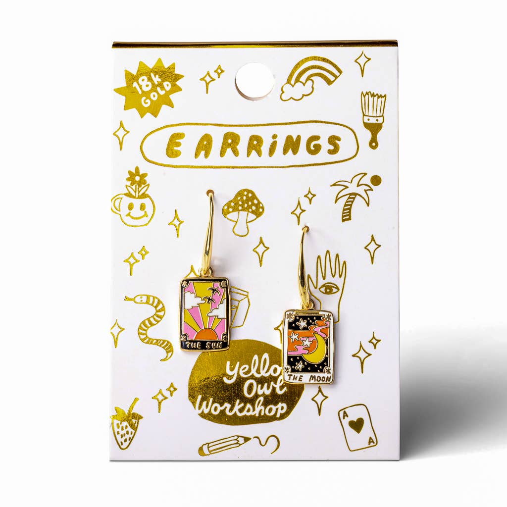 Earring packaging with artistic designs and 'Yello Out Workshop' branding on a white background.