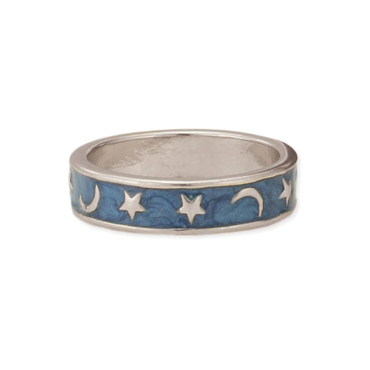 Silver ring with star and moon designs on a blue background