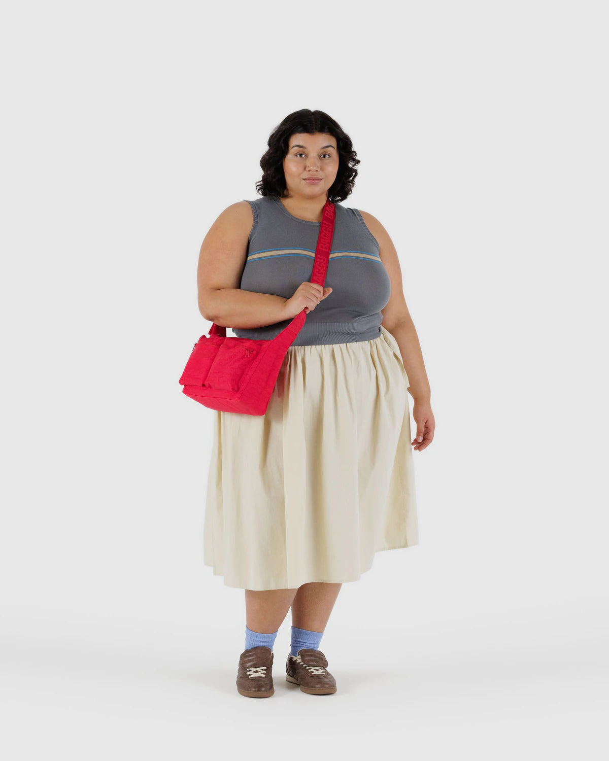 Woman holding a red bag against a white background