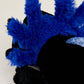 Close-up of a blue and black plush toy with fluffy texture.
