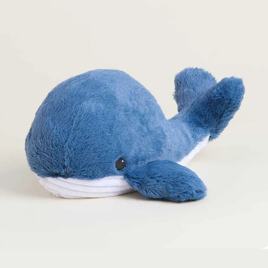 Blue plush whale toy on a light beige background