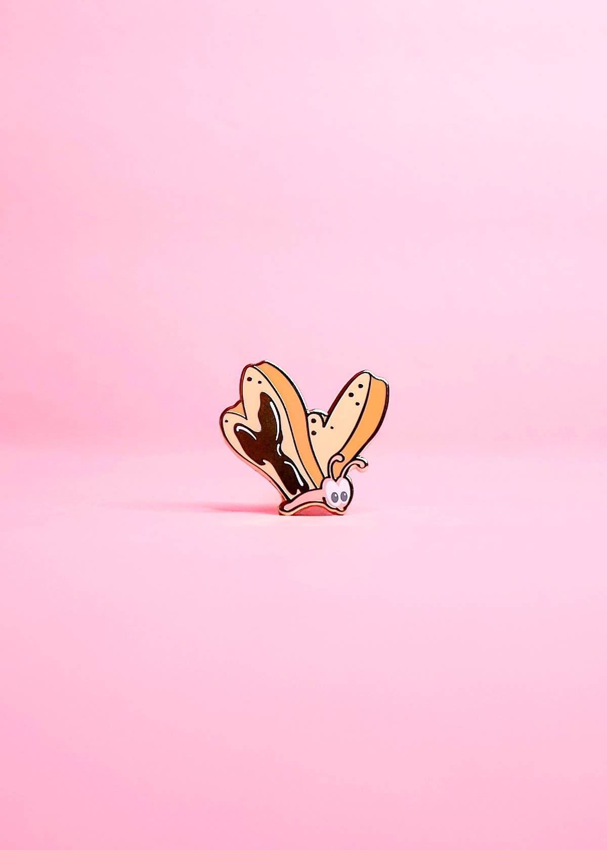 bread and butterfly pin on a pink background.