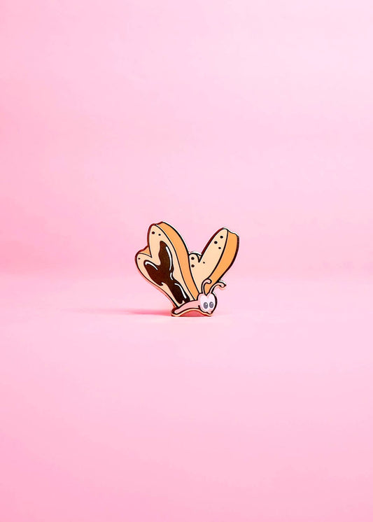 bread and butterfly pin on a pink background.