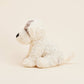 White plush dog toy on a beige background