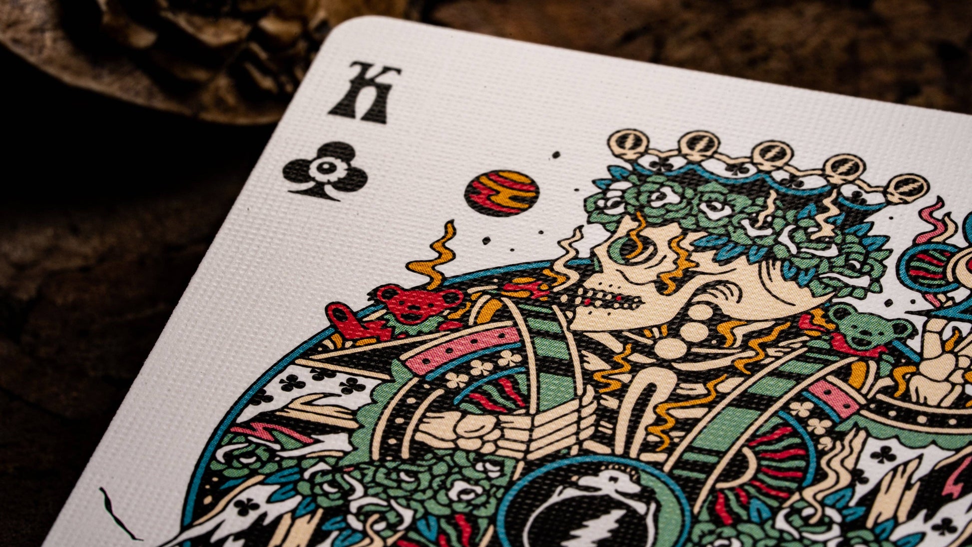 Colorful King of Clubs playing card with intricate design on a dark background