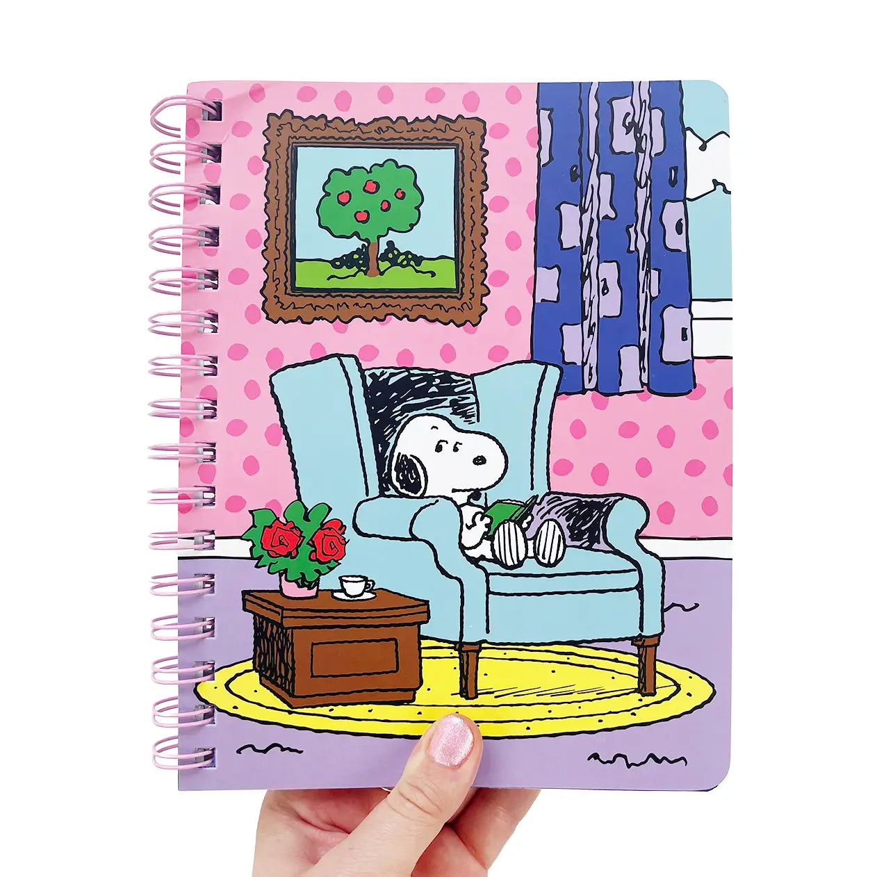 Notebook with a snoopy sitting on a couch in a living room.
