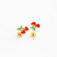 Gold earrings with red cherries on a white background