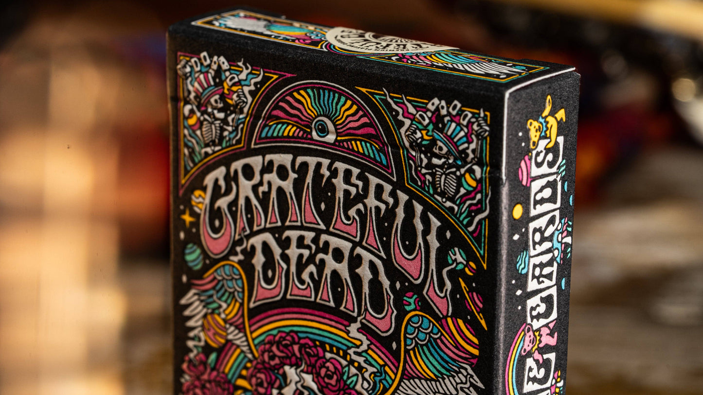 Grateful Dead playing cards box with colorful design on a blurred background