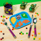 Children's table setting with colorful plate, cutlery, and snacks on a wooden surface.