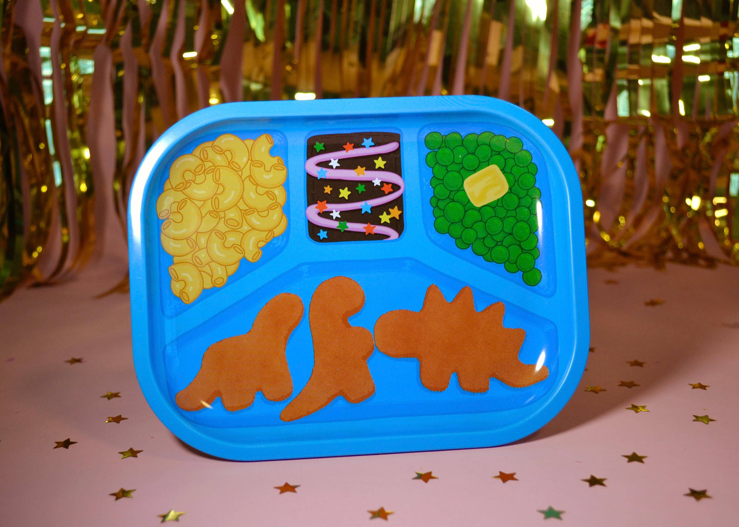 Children's blue tray with dinosaur-shaped compartments on a festive background