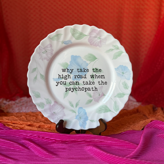Decorative plate with floral design and text on a colorful background
