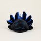 Black and blue axolotl plush toy on a white background