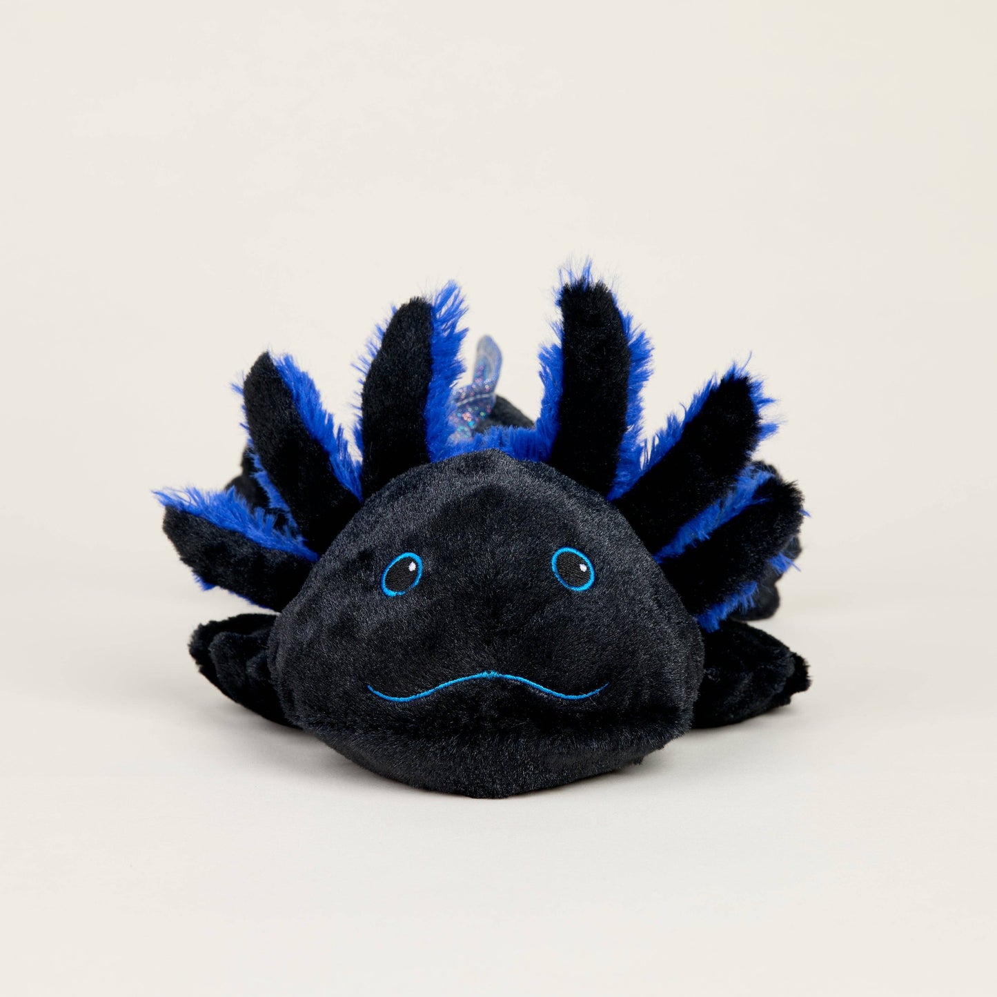 Black and blue axolotl plush toy on a white background