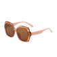 Sunglasses with a brown lens and pink frame on a white background