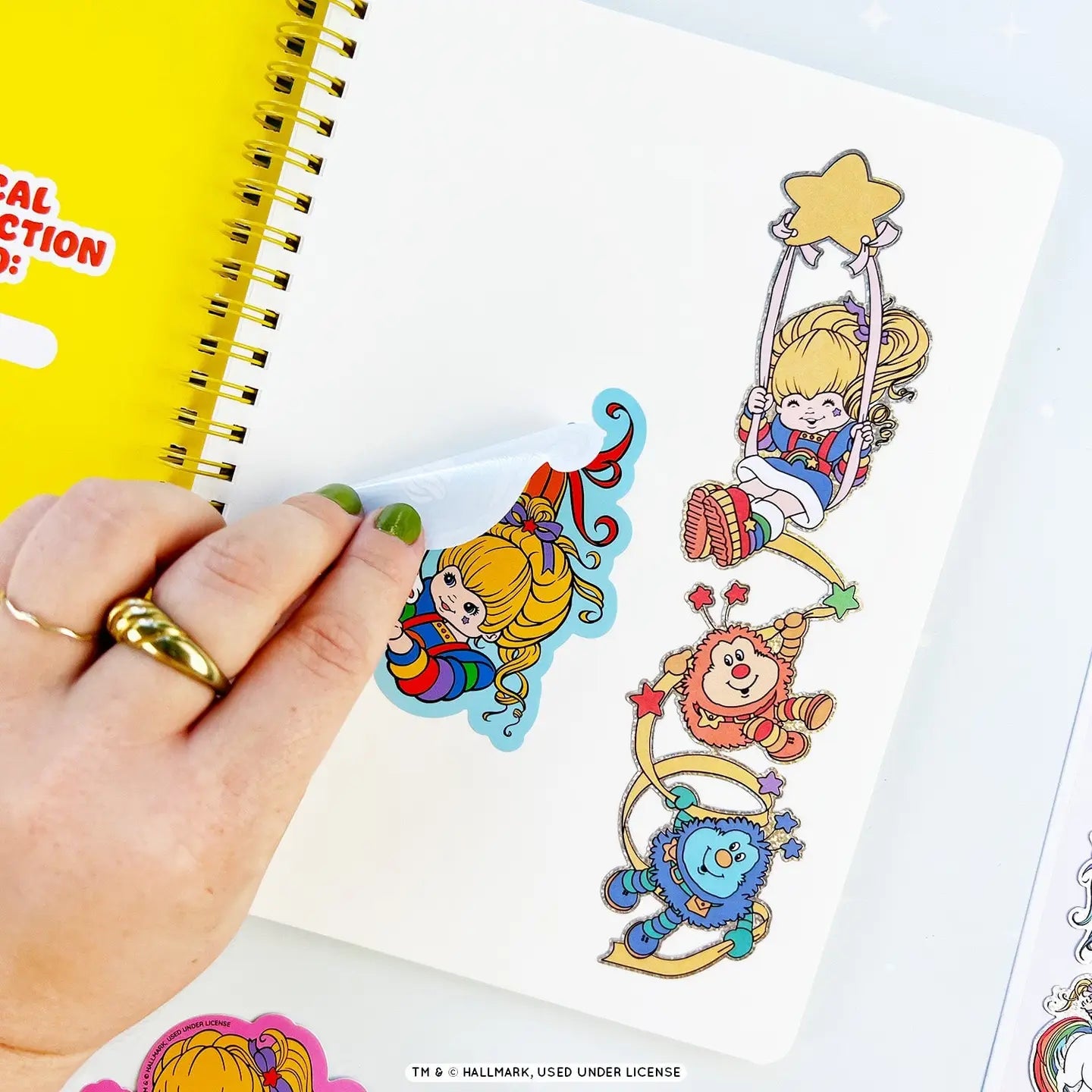 Sticker book with Rainbow Brite cartoon characters on a white surface