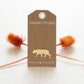 Gold necklace with a tiger pendant on an Amano Studio card with decorative elements.