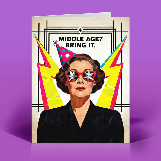 Greeting card with a woman wearing party hats and sunglasses, text 'MIDDLE AGE? BRING IT.' on a purple background