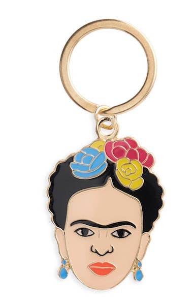 Keychain with a stylized portrait of a woman with colorful flowers in her hair on a white background