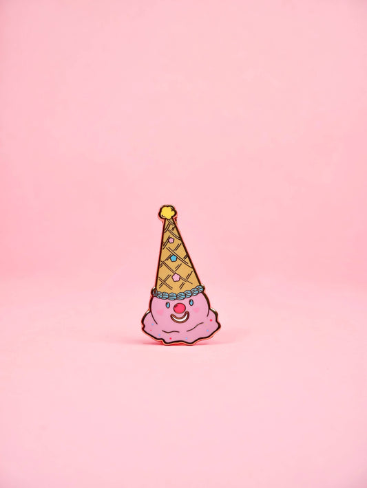 Pink clown figurine with a yellow party hat on a pink background