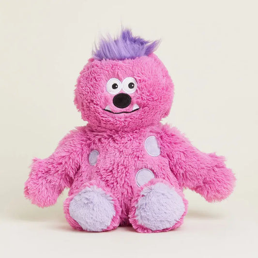 Pink plush toy with purple hair on a light beige background