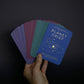 Hand holding a deck of cards titled 'Planet Grief' against a dark background