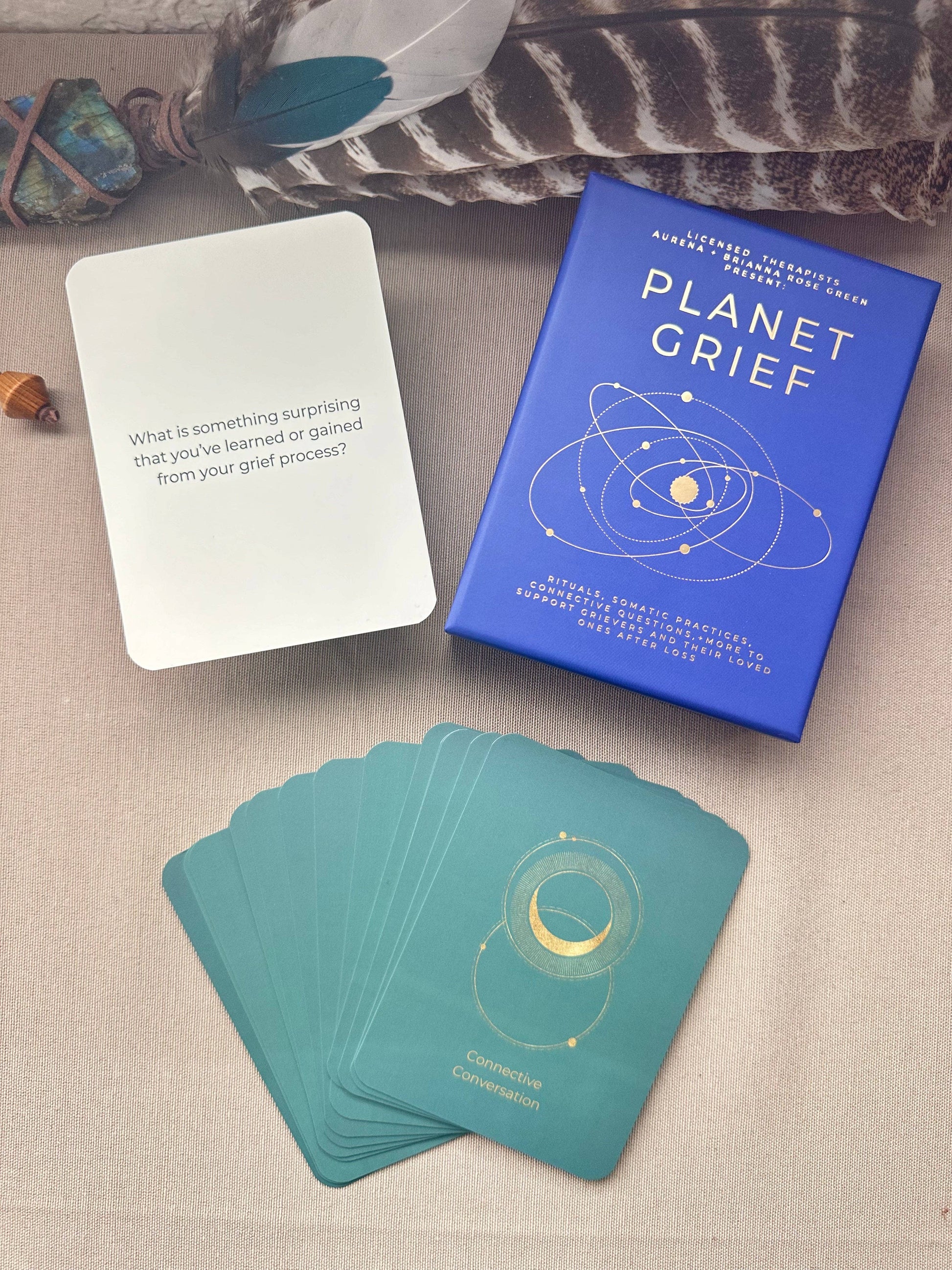 Card game set with 'Planet Grief' cards and box on a textured surface