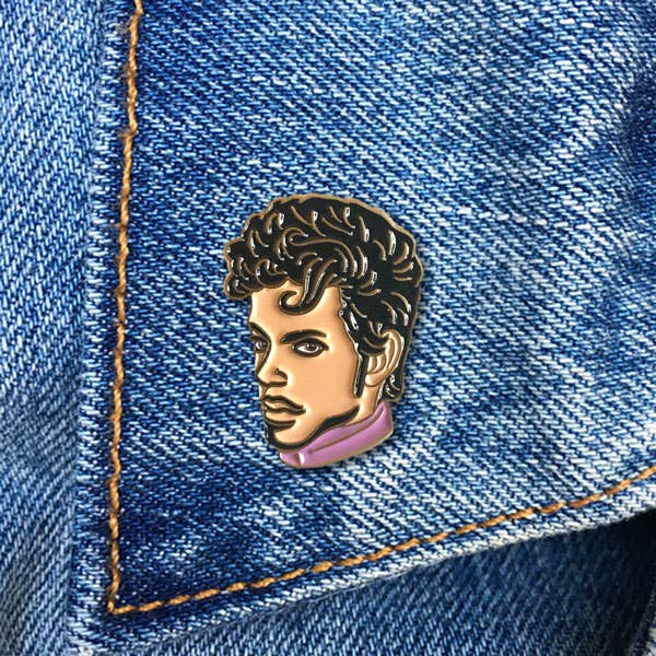 Pin of a person's face on a denim background
