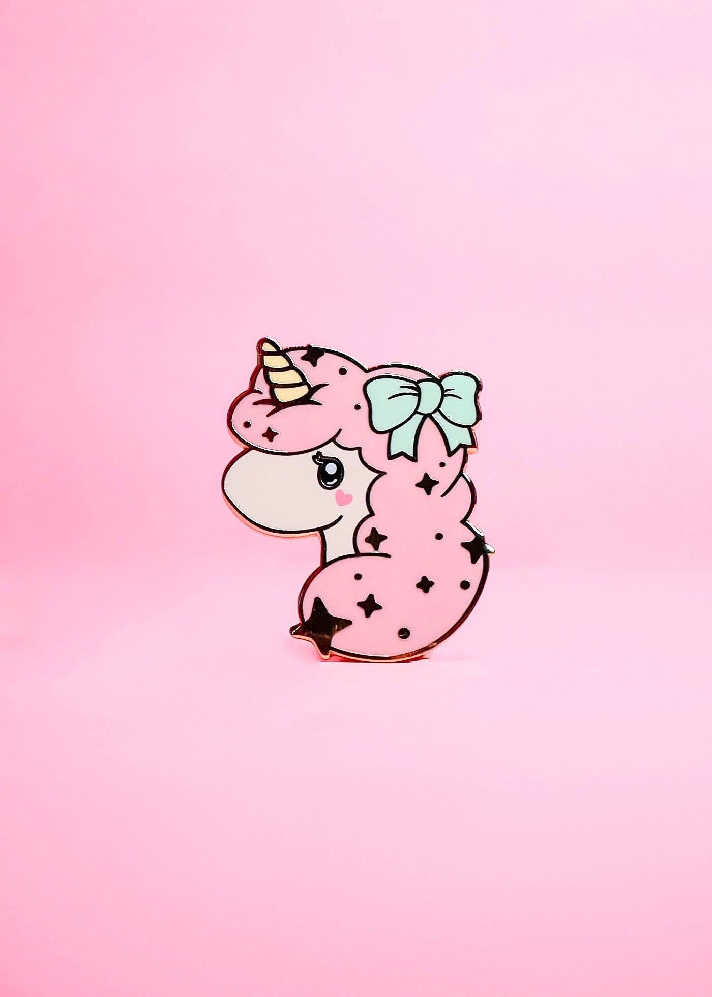 Cartoon unicorn with a bow on a pink gradient background